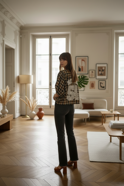 Ultra realistic fashion editorial series of 4 photos of a woman with Jane Birkin’s aspect wearing this brown chequered print shirt with dark grey flared jeans and high heel plattform sandals in camel color , she is posing showing the back of the shirt with the llettering " STUDIO 54" made with white lace , shootoing in a Haussmanian Parisian apartment , retro minimalistic deco , with some plants , natural make up , effortless chic attitude , natural golden hour lighting from big window ,  fashion EDITORIAL 